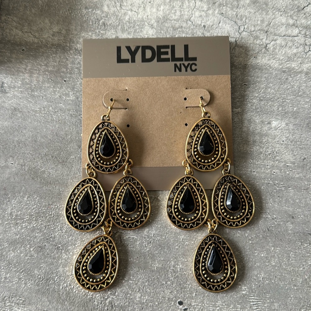 Fashion jewelry. Gold with black dangling earring. Never worn.